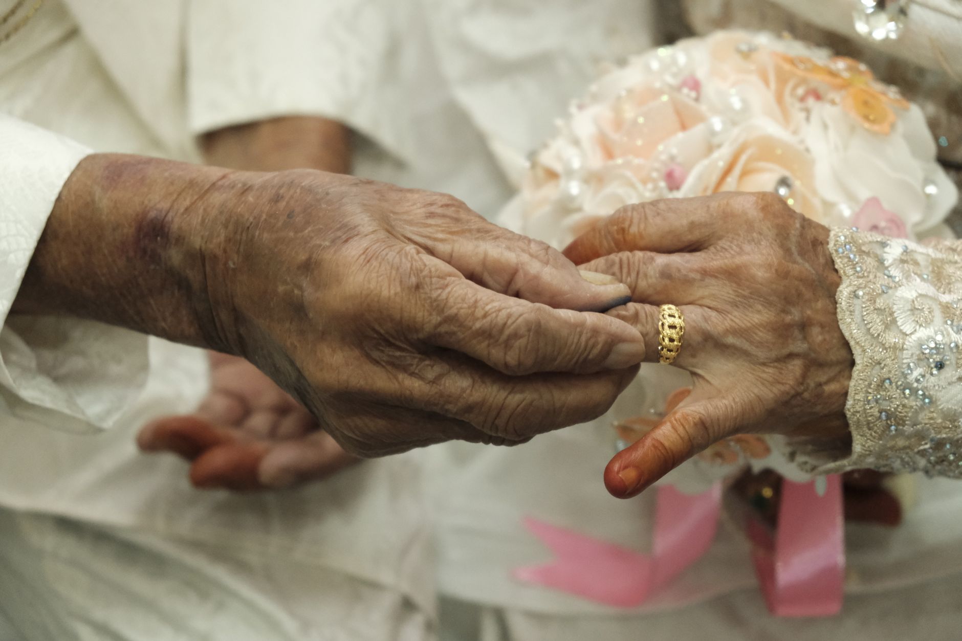 An illustration of a couple with an age gap facing social challenges, with icons representing five social challenges in their