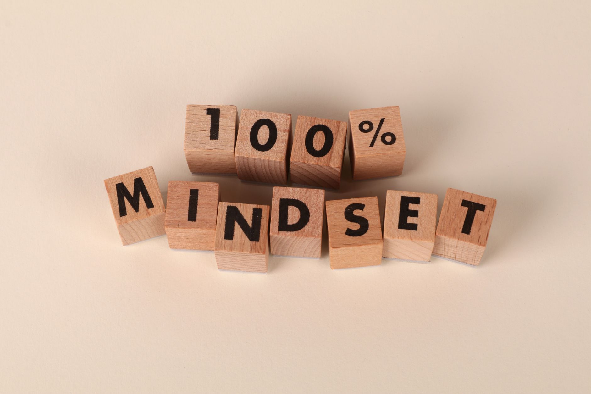 Wooden blocks spelling "100% MINDSET" to illustrate the concept of growth mindset.