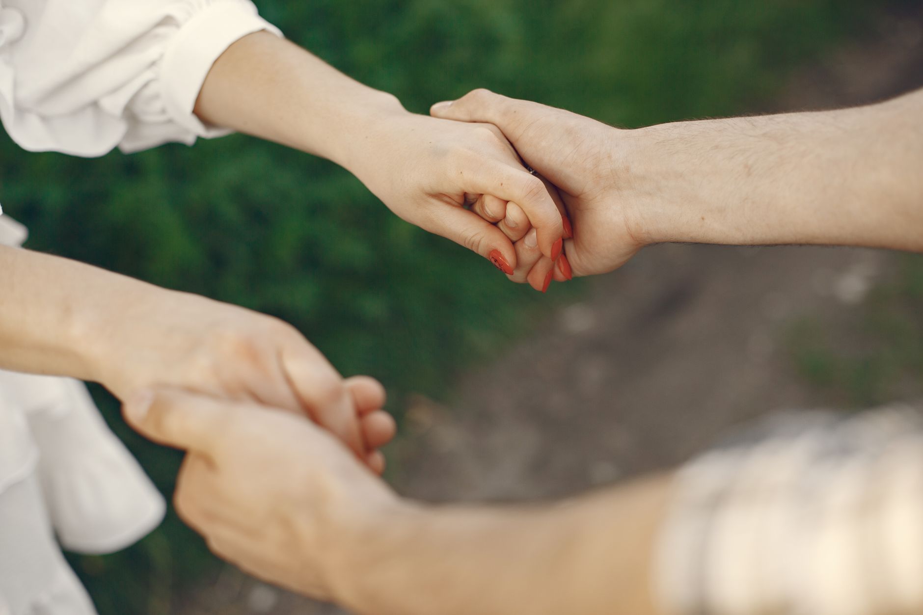 A couple holding hands in a park, illustrating Karmic Relationship dynamics.